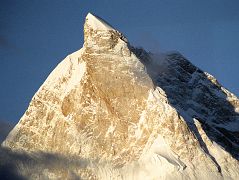 
The next morning dawned clear with the first rays of the sun hitting Masherbrum with its ice cream cone top glistening in the sun from Goro II. The summit of Masherbrum's sheer north face is a perfect pyramid, with steep narrow ridges rising suddenly to a sharp pinnacle. It was first climbed via the south west face on July 6, 1960 by George Bell and Willi Unsoeld on an American - Pakistani expedition. Two few days later on July 8, expedition leader Nick Clinch and Pakistani Captain Jawed Akhter Khan also reached the summit.
